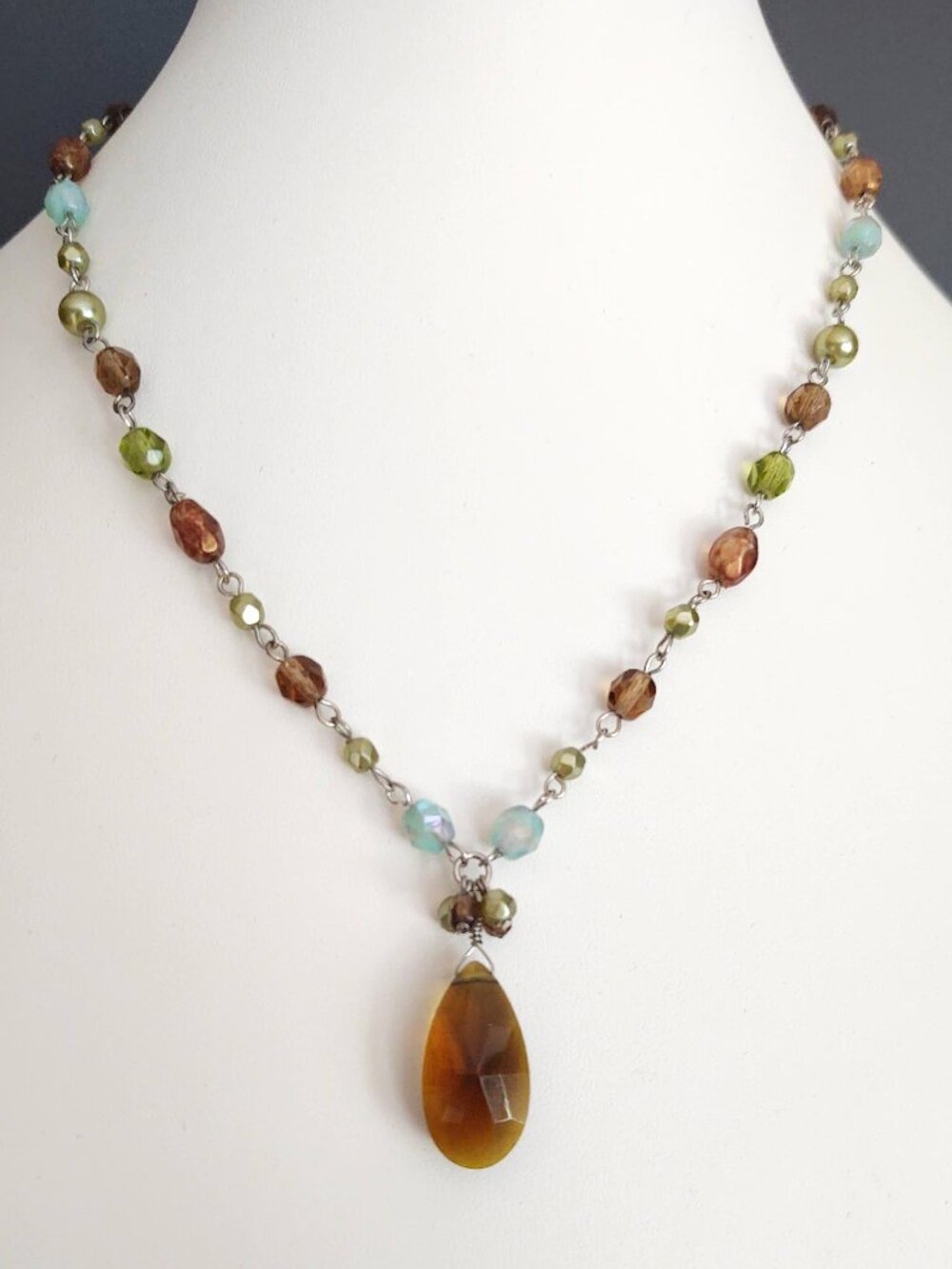 Green, blue and cognac beaded necklace with faceted cognac glass pendant